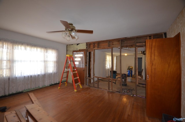 interior space featuring wood finished floors and a ceiling fan