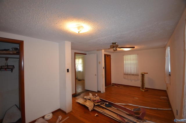 bedroom featuring wood finished floors and a textured ceiling