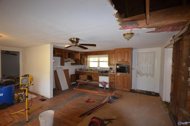 kitchen with a ceiling fan, brown cabinetry, white dishwasher, and black microwave