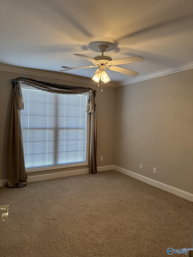 carpeted spare room with ceiling fan, baseboards, and ornamental molding