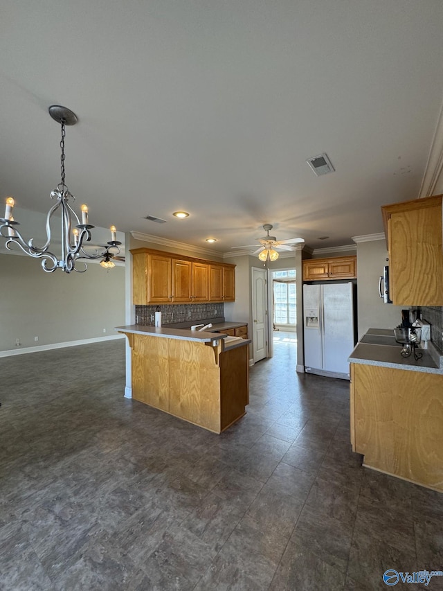 kitchen with visible vents, backsplash, ceiling fan with notable chandelier, a peninsula, and white refrigerator with ice dispenser