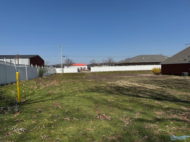 view of yard featuring cooling unit and fence