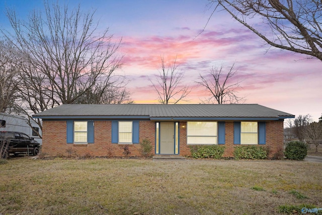 ranch-style house featuring a yard