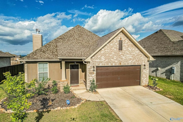 view of front of home featuring a front lawn and a garage