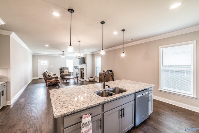 kitchen featuring a healthy amount of sunlight, sink, an island with sink, and stainless steel dishwasher