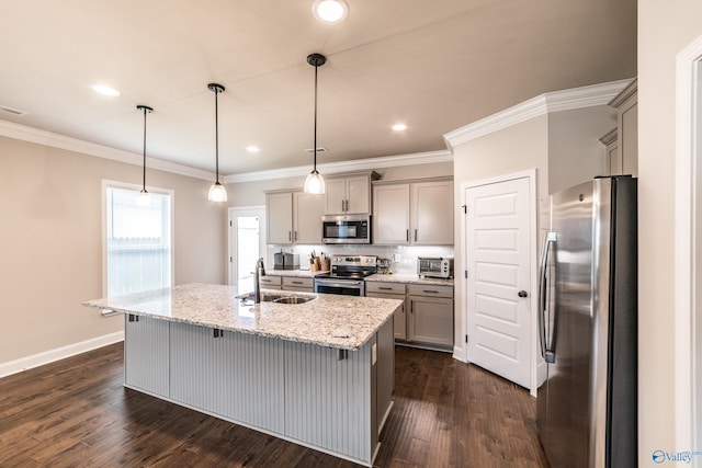 kitchen featuring dark hardwood / wood-style flooring, sink, pendant lighting, and appliances with stainless steel finishes