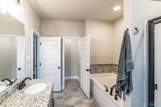 bathroom with a bathing tub and vanity