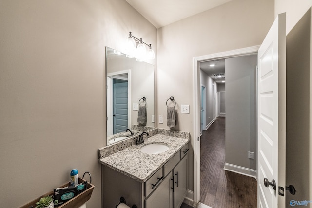 bathroom with vanity and hardwood / wood-style flooring