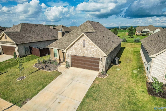 view of front of home featuring a garage, a front lawn, and central air condition unit