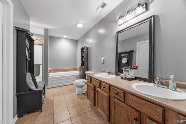 20729 Colonial Dr, Athens, AL 35614 - full bath with double vanity, a bath, toilet, and tile patterned flooring