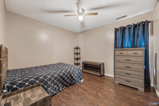 20729 Colonial Dr, Athens, AL 35614 - bedroom with wood finished floors, a textured ceiling, baseboards, and a ceiling fan