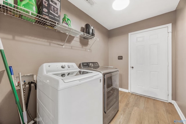 20729 Colonial Dr, Athens, AL 35614 - laundry room featuring light wood-style floors, separate washer and dryer, and baseboards