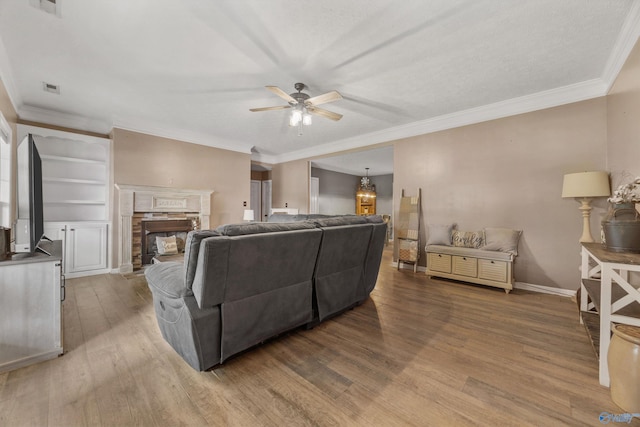 20729 Colonial Dr, Athens, AL 35614 - living room with a ceiling fan, wood finished floors, crown molding, a fireplace, and baseboards