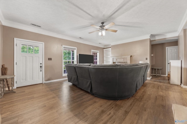20729 Colonial Dr, Athens, AL 35614 - living room featuring ceiling fan, wood finished floors, baseboards, a textured ceiling, and crown molding