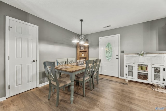 20729 Colonial Dr, Athens, AL 35614 - dining space with wood finished floors, baseboards, and a chandelier