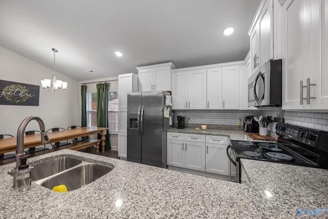 kitchen featuring pendant lighting, sink, white cabinets, stainless steel appliances, and light stone countertops