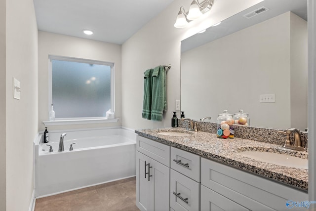 bathroom featuring vanity and a washtub