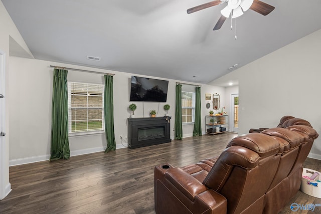 living room with ceiling fan, lofted ceiling, and dark hardwood / wood-style floors