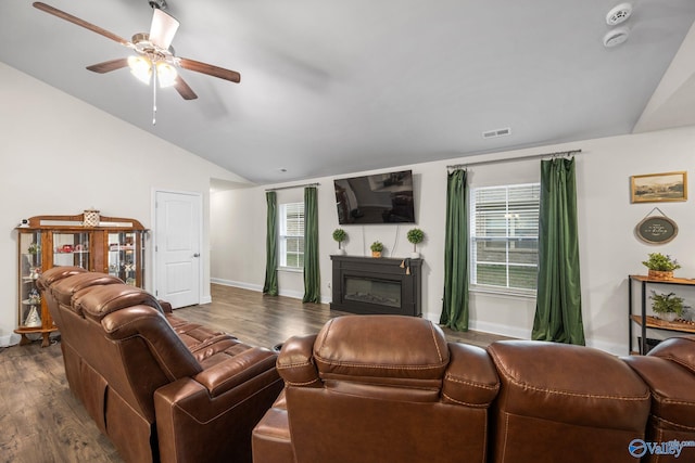 living room with vaulted ceiling, dark hardwood / wood-style floors, and ceiling fan