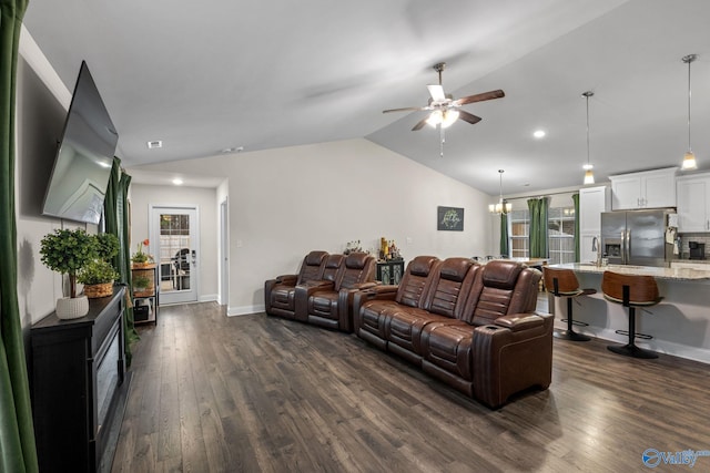 living room with ceiling fan with notable chandelier, sink, dark hardwood / wood-style floors, and vaulted ceiling