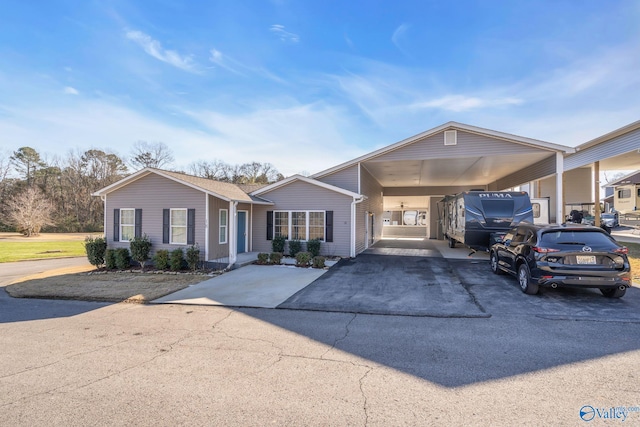 view of front of house featuring driveway and an attached carport