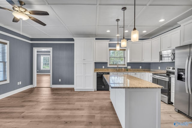 kitchen featuring a center island, stainless steel appliances, hanging light fixtures, white cabinetry, and light stone countertops