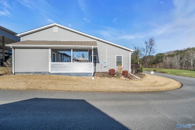 view of front of home with a shingled roof