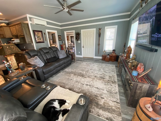 living room featuring crown molding, wood-type flooring, a wall unit AC, and ceiling fan