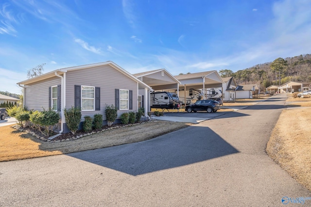 view of front of property with driveway and a carport