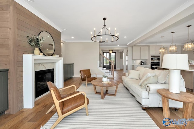 217 Idle Creek Dr, Huntsville, AL 35811 - living area with recessed lighting, a high end fireplace, light wood-style flooring, and an inviting chandelier