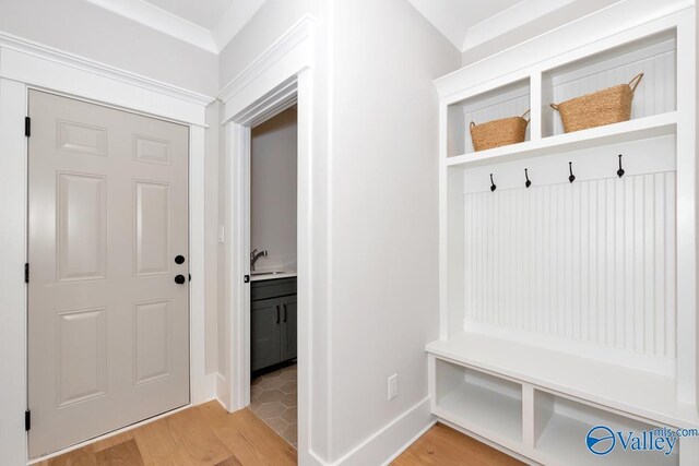 217 Idle Creek Dr, Huntsville, AL 35811 - mudroom featuring a sink, light wood-style flooring, and baseboards