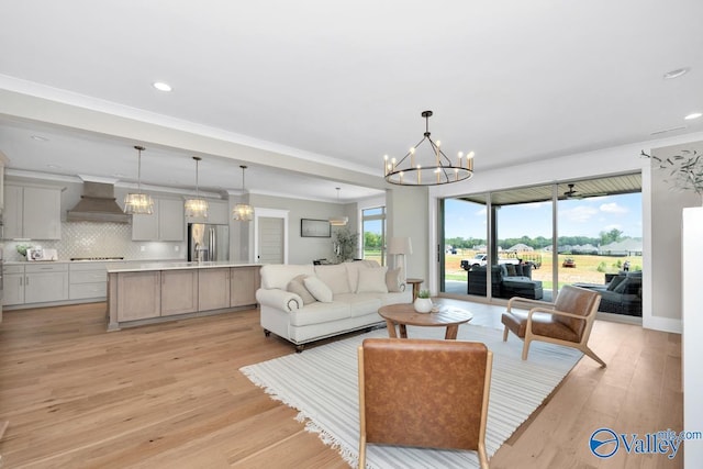 217 Idle Creek Dr, Huntsville, AL 35811 - living area featuring light wood-type flooring, a notable chandelier, ornamental molding, and recessed lighting