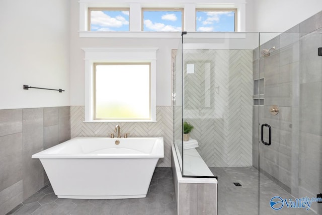 217 Idle Creek Dr, Huntsville, AL 35811 - full bath with tile patterned floors, tile walls, a stall shower, and a healthy amount of sunlight