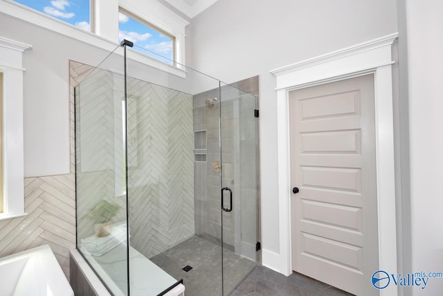 217 Idle Creek Dr, Huntsville, AL 35811 - bathroom featuring a washtub, tile patterned floors, and a shower stall