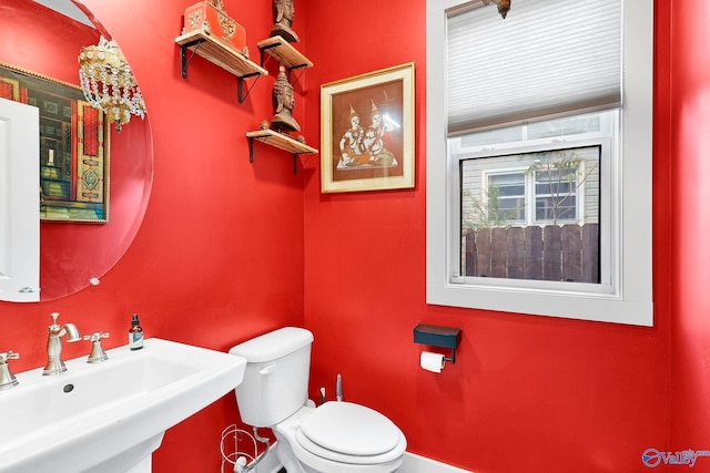 half bath featuring a sink and toilet