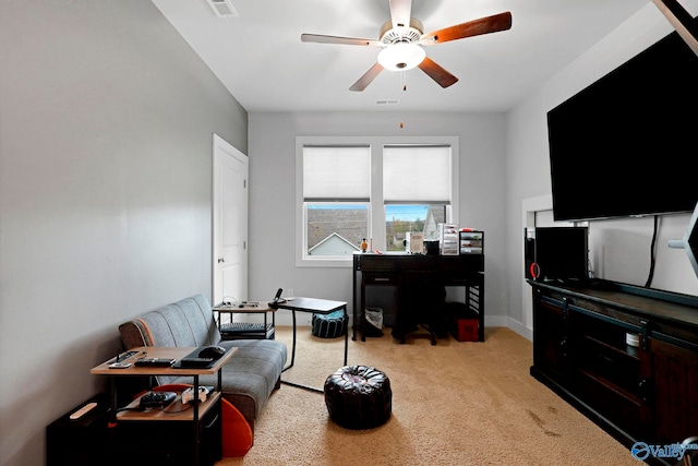 carpeted living room with ceiling fan and baseboards