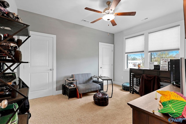 carpeted office space with ceiling fan, visible vents, and baseboards