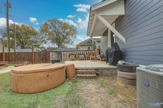 exterior space with a patio, central AC unit, fence, and a hot tub