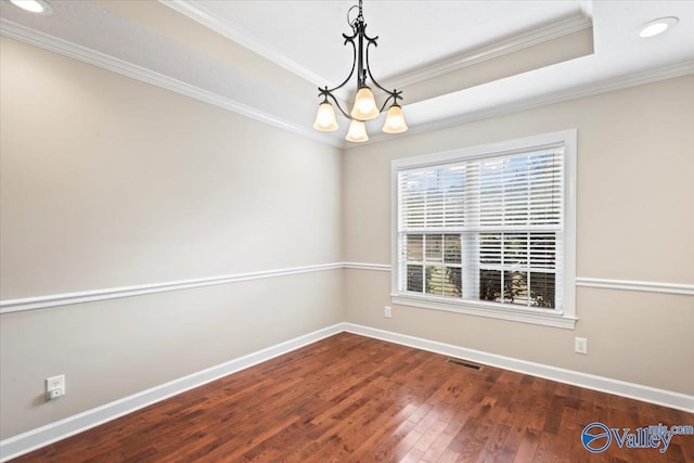 unfurnished room featuring dark hardwood / wood-style flooring, a notable chandelier, and ornamental molding