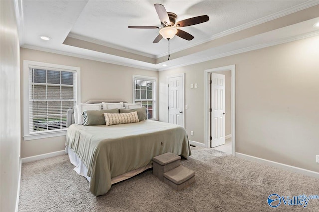 bedroom with a raised ceiling, ceiling fan, crown molding, and light colored carpet