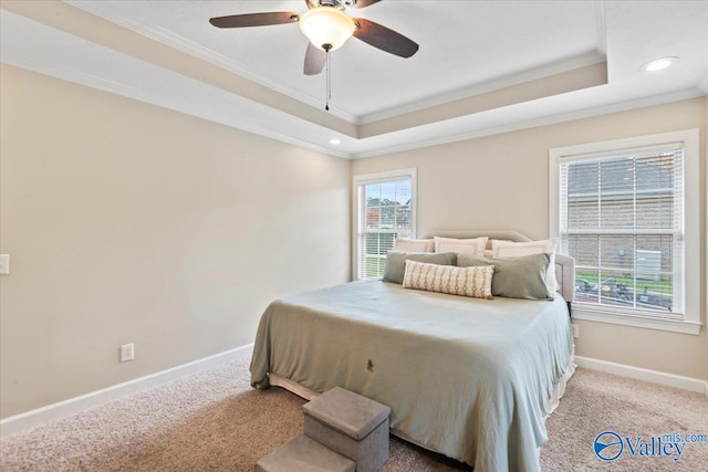 bedroom with light carpet, a tray ceiling, ceiling fan, and ornamental molding