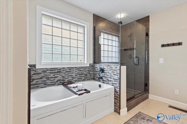 bathroom featuring tile patterned floors, separate shower and tub, and tasteful backsplash