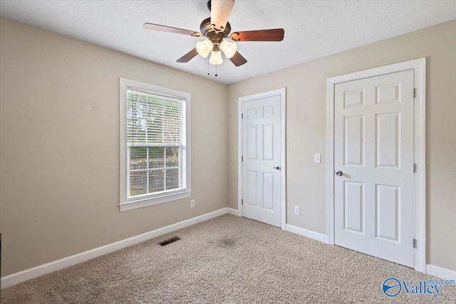 unfurnished bedroom featuring carpet and ceiling fan