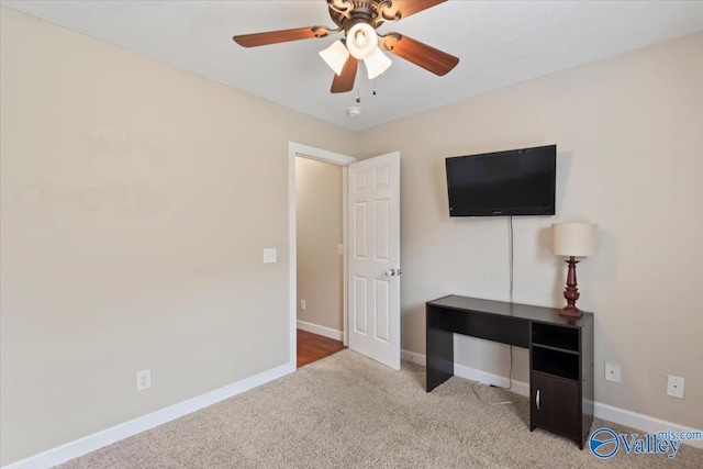 interior space with ceiling fan and light carpet