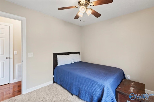 bedroom with hardwood / wood-style floors and ceiling fan