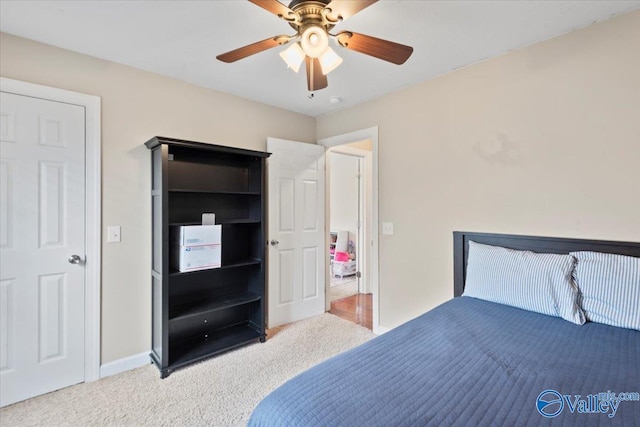 bedroom with ceiling fan and light colored carpet