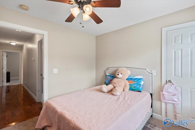 bedroom with hardwood / wood-style floors and ceiling fan