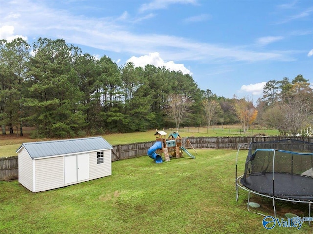 view of yard featuring a playground, a trampoline, and a shed