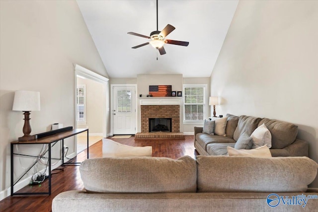 living room featuring dark hardwood / wood-style floors, ceiling fan, a fireplace, and high vaulted ceiling