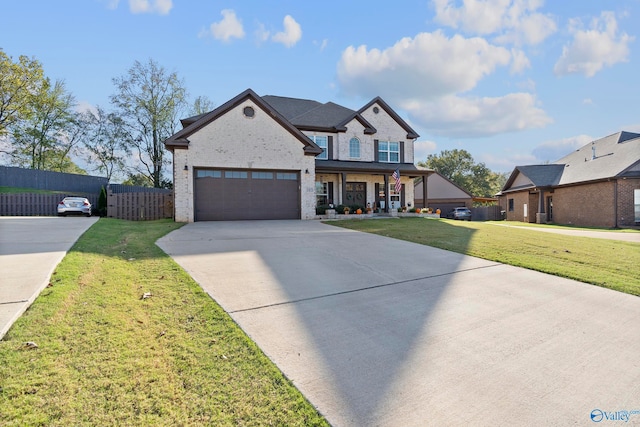 view of front facade with a garage, a front yard, and covered porch